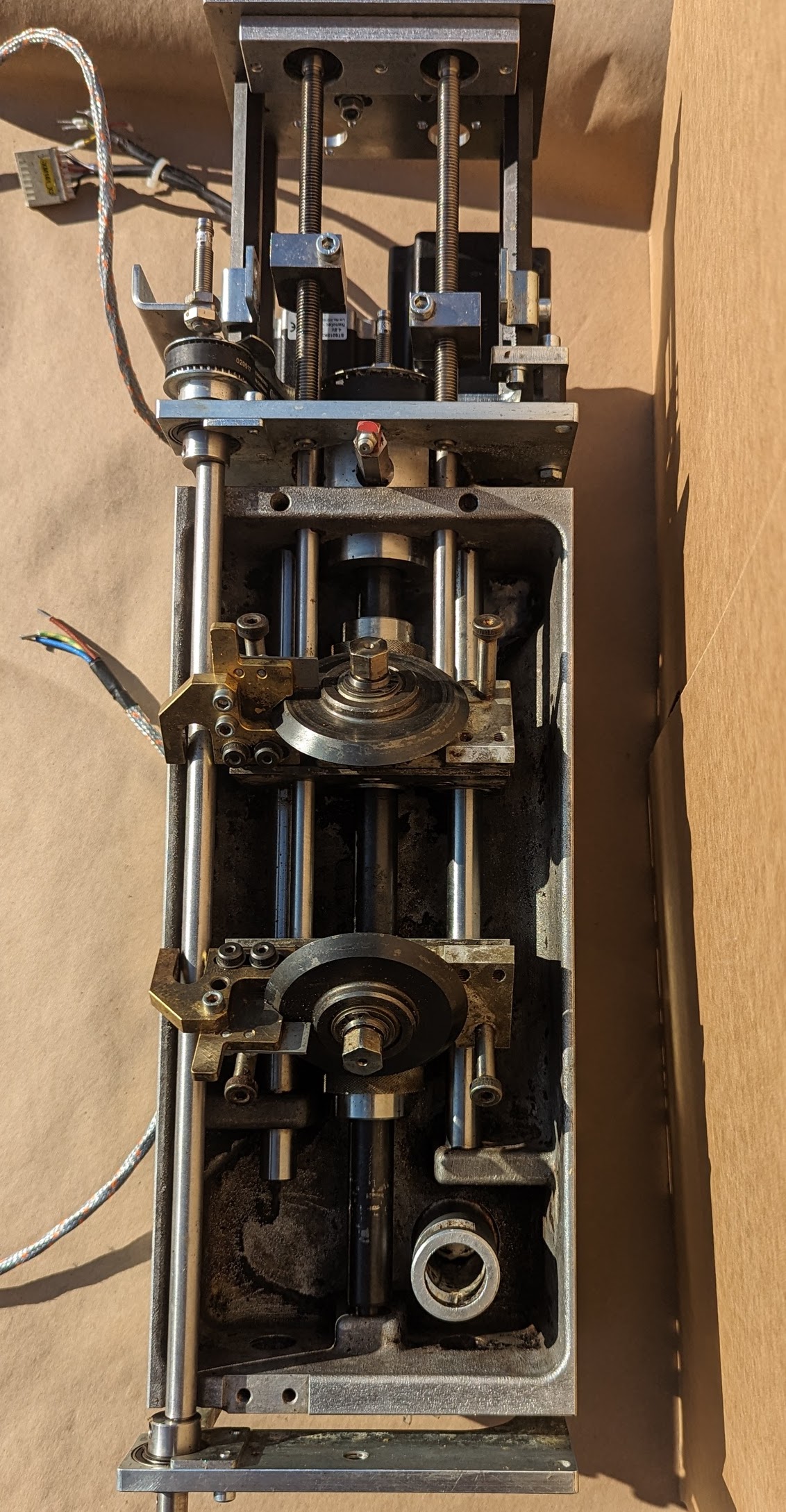 Full cam and actuator assembly after cleaning — lead screws, cam followers, and brass fittings clean