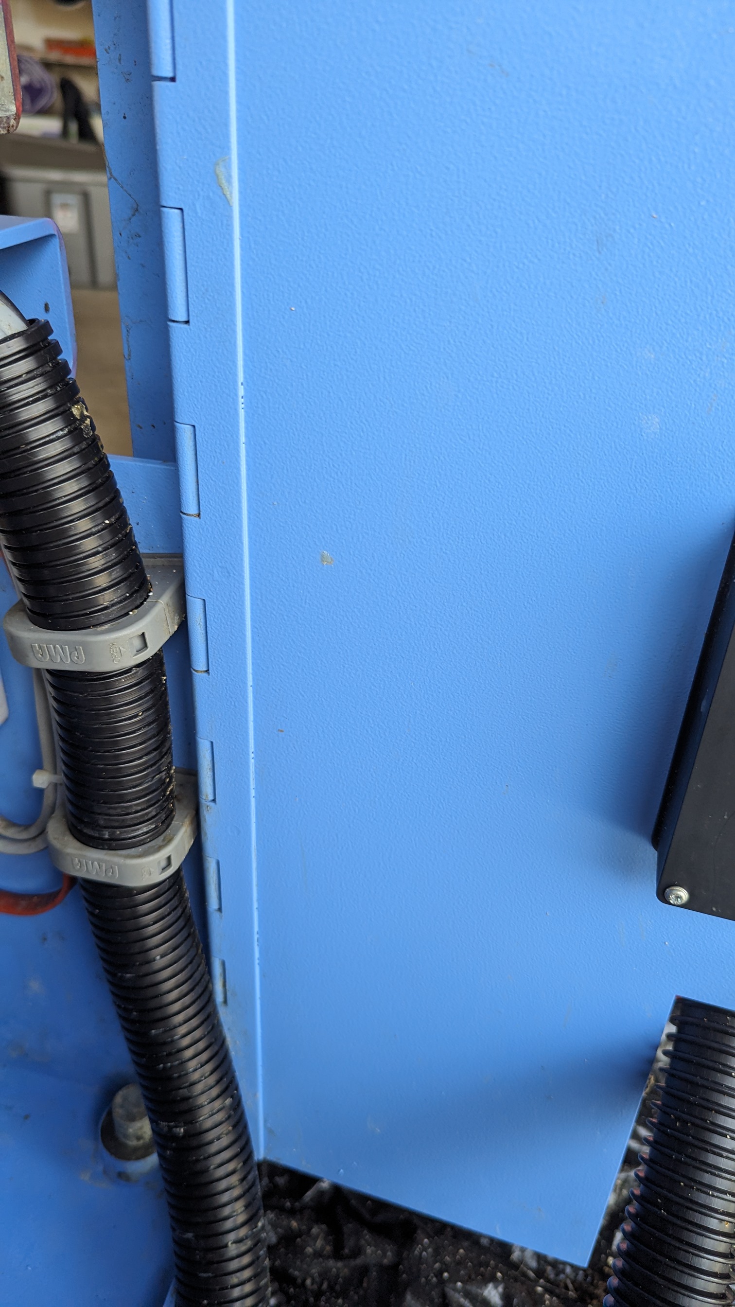 Same corrugated conduit after cleaning — clean grooves, clean machine panel